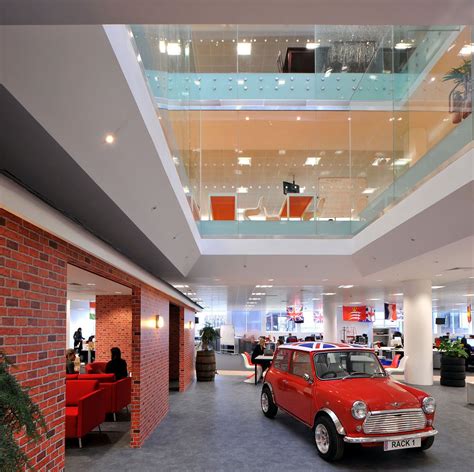 An Old Red Car Is Parked In The Middle Of A Large Room With High Ceilings