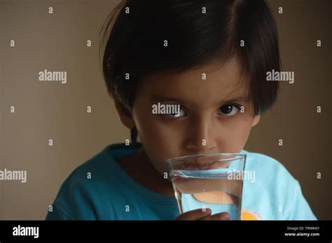 Girl Drinking A Glass Of Water Stock Photo Alamy