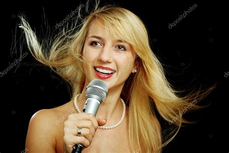 Blonde Girl With Naked Shoulders Singing Karaoke Stock Photo By Pekour