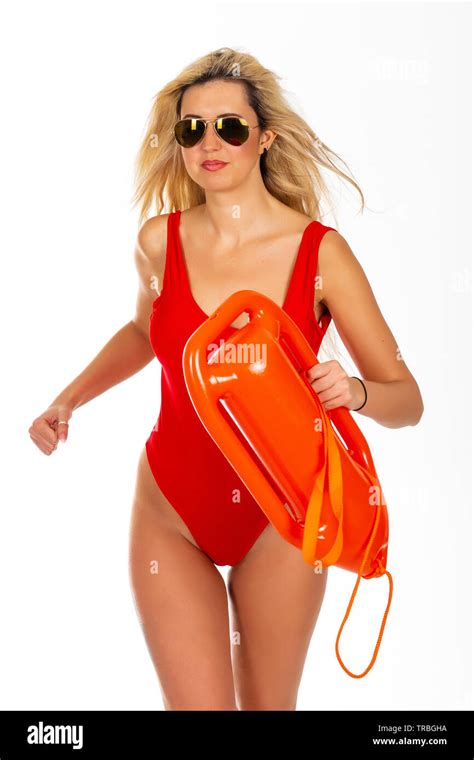 Pretty Young Blonde Lifeguard In Red Sexy Swimsuit With Lifeguard Rescue Can Floating Buoy