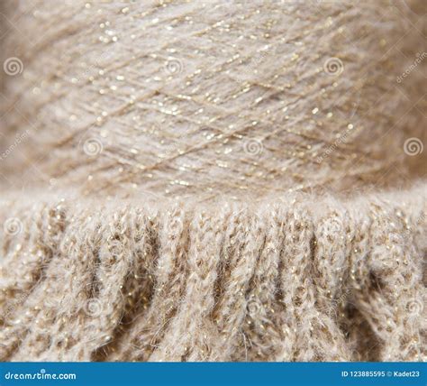 Nude And Gold Color Spool Of Thread And Knitted Textile Stock Image