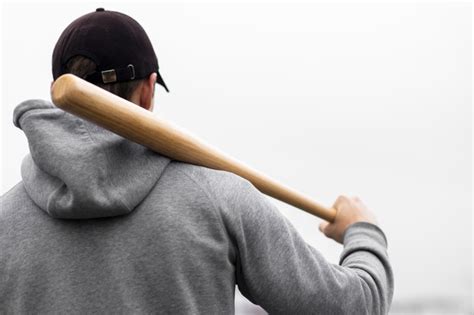 Free Back View Of Man Holding Baseball Bat On Shoulder Free Photo
