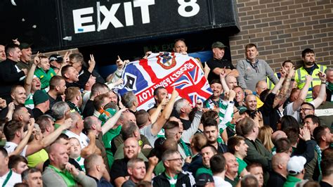 celtic fans taunt rangers rivals with upside down gers flag before police take it away the