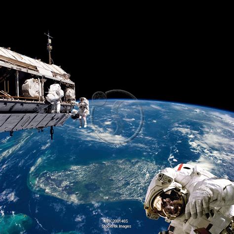 Astronauts Performing Work On Space Station While Orbiting Above Earth