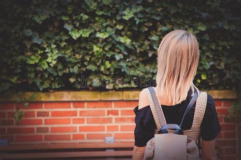 Girl With Backpack Looking At Bush And Brick Wall Stock Image Image Of Autumn Fall 126252839