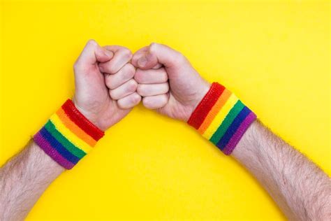 Premium Photo Fist Hand With Gay Pride Rainbow Flag Wristband On A