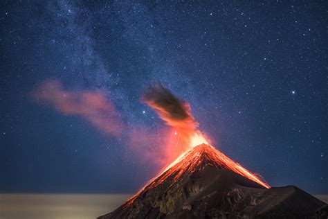 See The Milky Way Behind An Erupting Volcano In These Incredible Photos