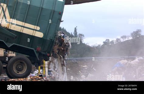Trash Pouring Out Of Garbage Truck Into Landfill Stock Video Footage