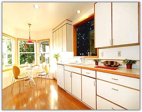 If you don't have windows in the kitchen, this isn't as much of a problem. White Cabinets With Wood Trim Kitchen - latest interior design