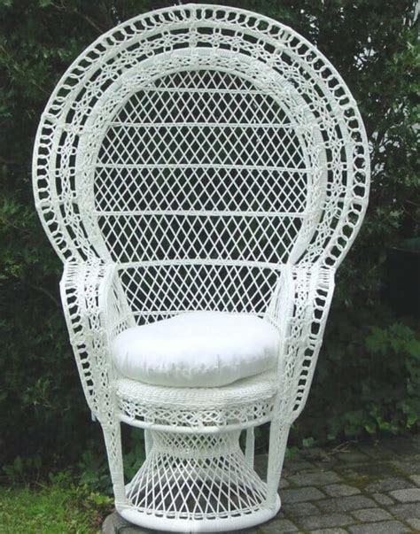 Wooden rattan armchairs with console and green plant. White Wicker Chair / Baby Shower Chair