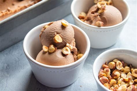Three Bowls Filled With Ice Cream And Nuts