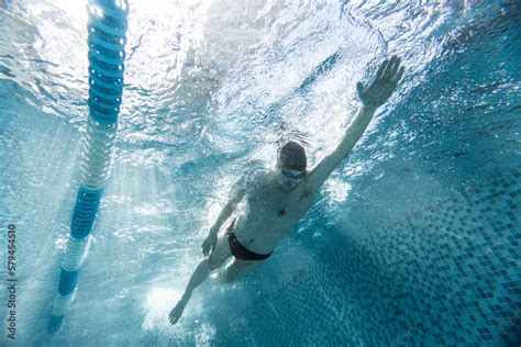 Underwater Shooting One Male Swimmer Training At Pool Indoors