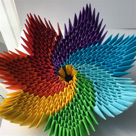A Multicolored Paper Sculpture Sitting On Top Of A White Table