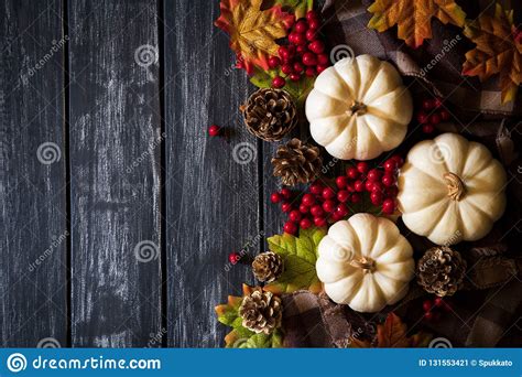 Autumn Maple Leaves With Pumpkin And Red Berries On Old Wooden