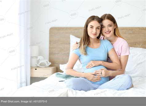 Happy Pregnant Lesbian Couple In Bedroom Stock Photography Agency Pixel Shot Studio