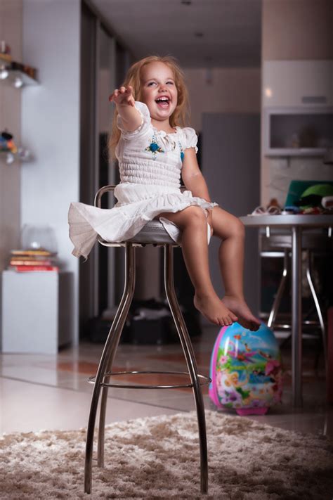 Happy Little Girl Sitting On A Metal Chair Stock Photo Free Download