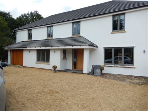 After Picture White Rendered House With Grey Windows And Grey Roof