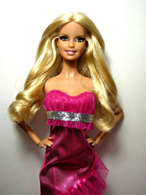 A Barbie Doll With Blonde Hair And Pink Dress