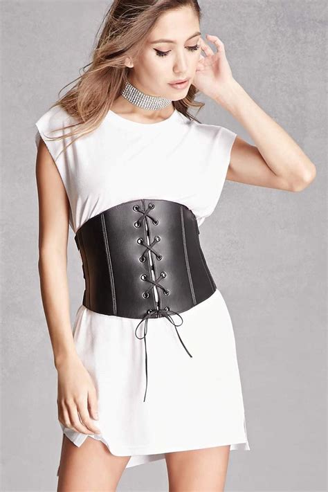 A Faux Leather Corset By Kikiriki™ Featuring Strapped Sides Hook Back Closures And A Lace Up