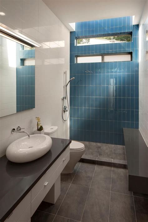 A Bright Blue Tile Accent Wall At The Back Of The Shower Adds Color To