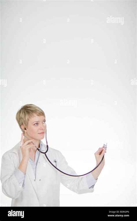 A Female Doctor Listening Into A Stethoscope Stock Photo Alamy