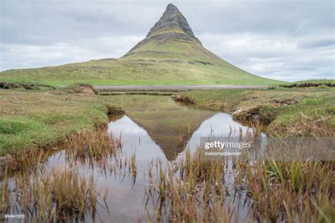 Famous Kirkjufell Mountain In Iceland Against Overcast Sky No People