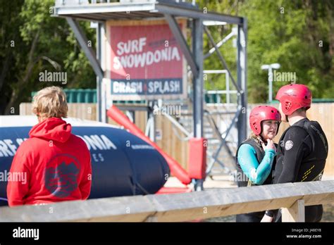visitors and life guard at the popular surf snowdonia artificial surf lake waiting for their