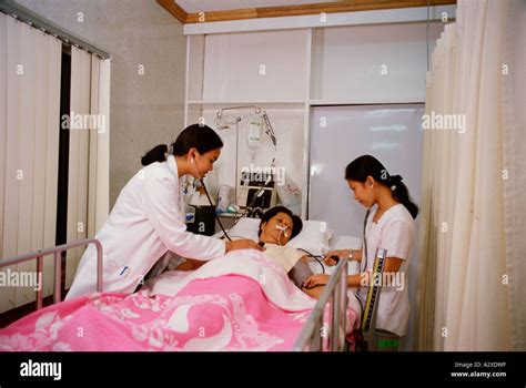 Medical Hospital Intensive Care Female Doctor Treating Woman In Bed