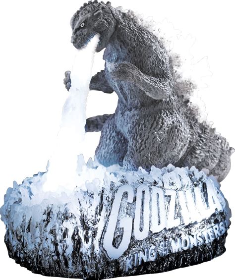 The Godzilla Statue Is On Display In Front Of A White Background With An Inscription Underneath It