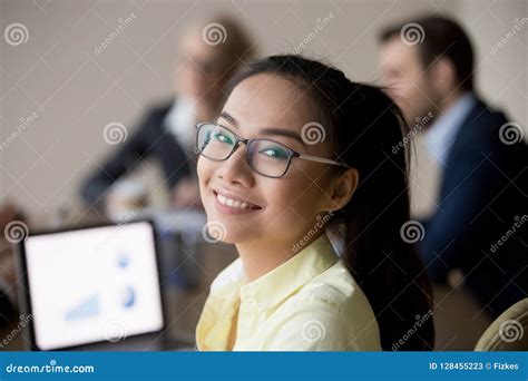 Portrait Of Smiling Asian Employee Looking At Camera During Meet Stock