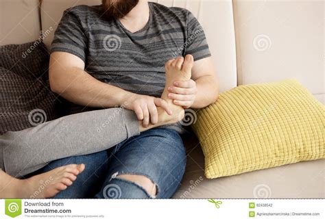 Young Man Massaging His Lover`s Feet Royalty Free Stock