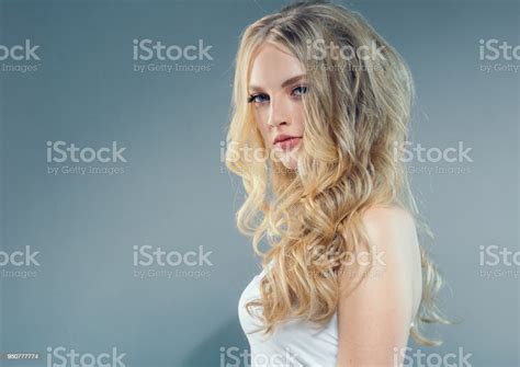 Young Nice Blonde Girl With Long Curly Fly Blonde Hair Woman Healthy Skin And Hairstyle Portrait