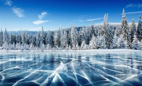 Blue Ice And Cracks On The Surface Of The Ice Frozen Lake Under A Blue