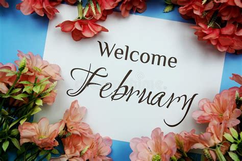 Welcome February Text With Pink Flower Frame On Blue Background Stock
