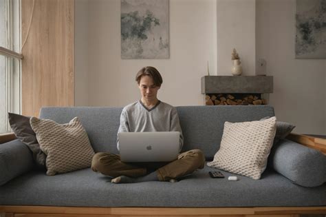 Man Sitting On Couch With A Laptop · Free Stock Photo