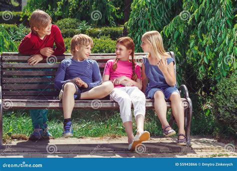 Nice Smiling Children Sitting On The Bench Stock Photo Image Of Crowd