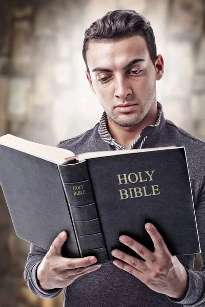 Guy Holding Holy Bible Stock Photo By ©amelaxa 115944330