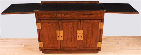 Campaign furniture which is designed to be 'folded up' and carried long distances has been a feature of travelling armies over many centuries. Henredon Elm Bar Cabinet With Campaign Style Hardware at ...