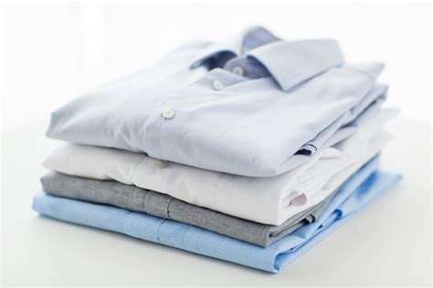 Close Up Of Ironed And Folded Shirts On Table Comet Cleaners