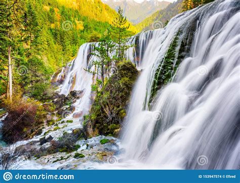 The Pearl Shoals Waterfall Among Wooded Mountains At Sunset Stock Photo