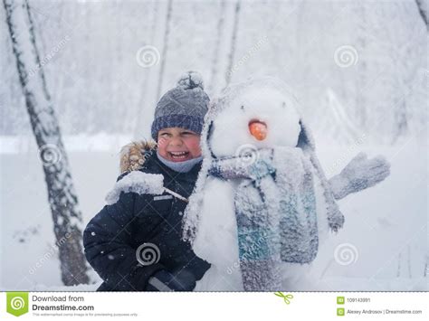 European Boy And The Snowman In A Snowy Forest Stock Image Image Of