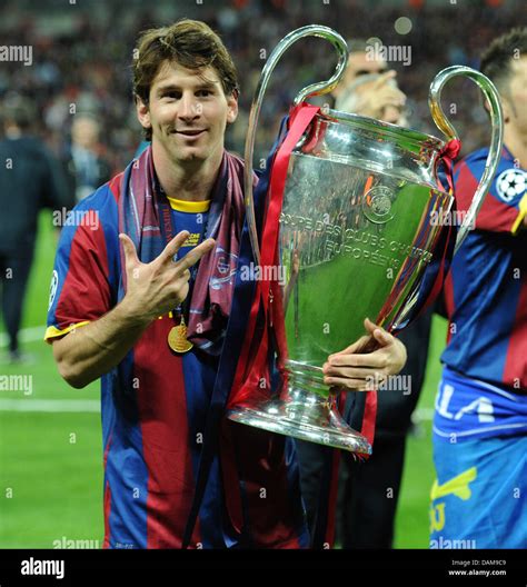 Barcelonas Lionel Messi Holds The Champions League Trophy After The