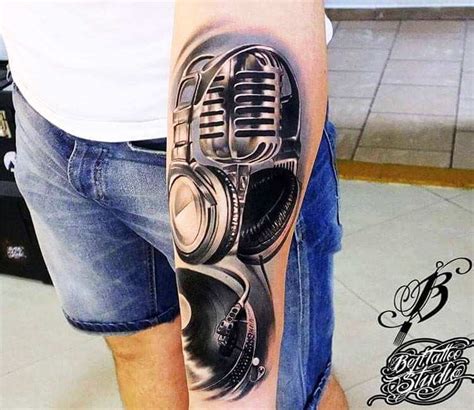 Realistic microphone in hand tattoo. Microphone tattoo by Bejt Tattoo | Post 21734