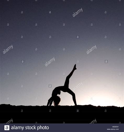 Woman Doing Yoga On The Beach Stock Photos And Woman Doing Yoga On The