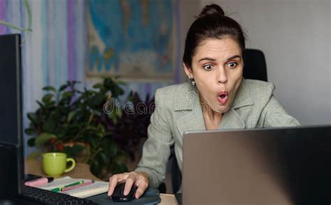 shocked business woman using laptop looking at computer screen at home office human face