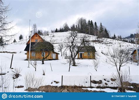Wooden Houses On The Side Of A Snowy Mountain In The Village Stock