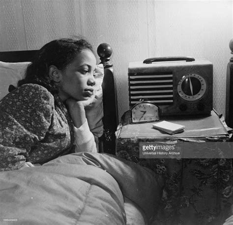 Photograph Of An African American Woman Listening To The Radio During