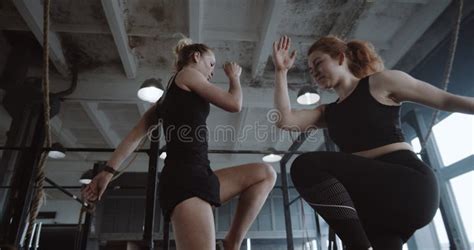 Two Young Beautiful Athletic European Women Doing Aerobic Physical Exercise Together In Large
