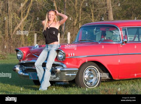 Young Girl Beautiful Woman Leaning On A Red 1955 Chevy Car Stock Photo