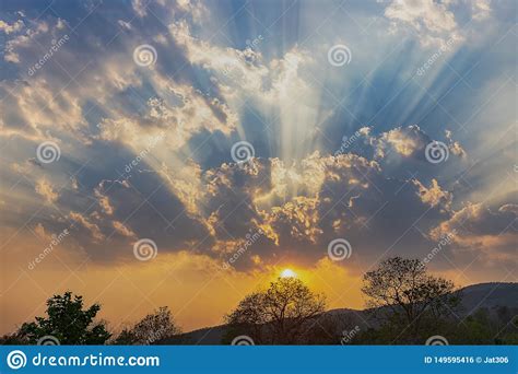 Beautiful Ray Of Sunlight Breaking Through Clouds At Sunset Stock Photo